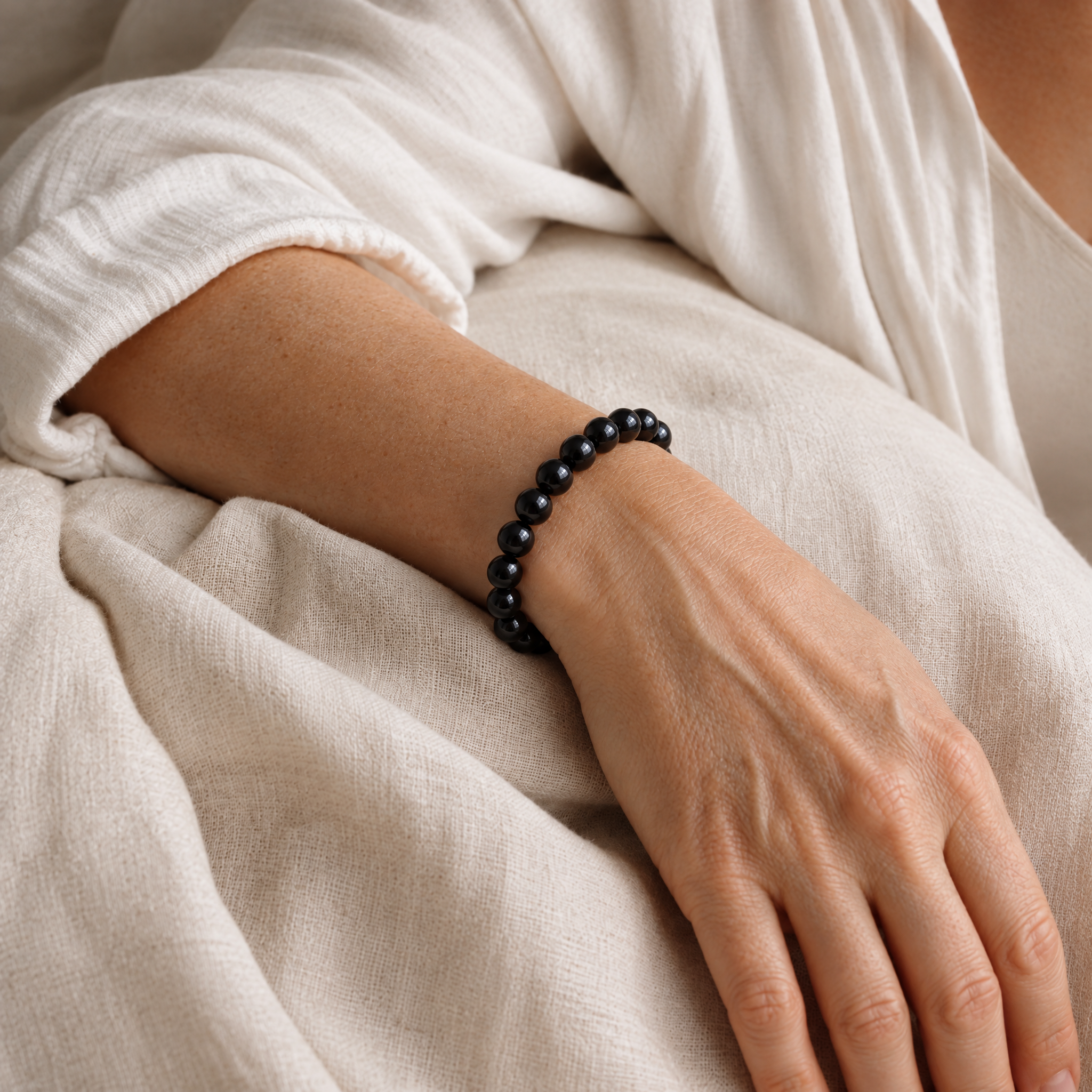 Woman wearing the black tourmaline bracelet in soft daylight