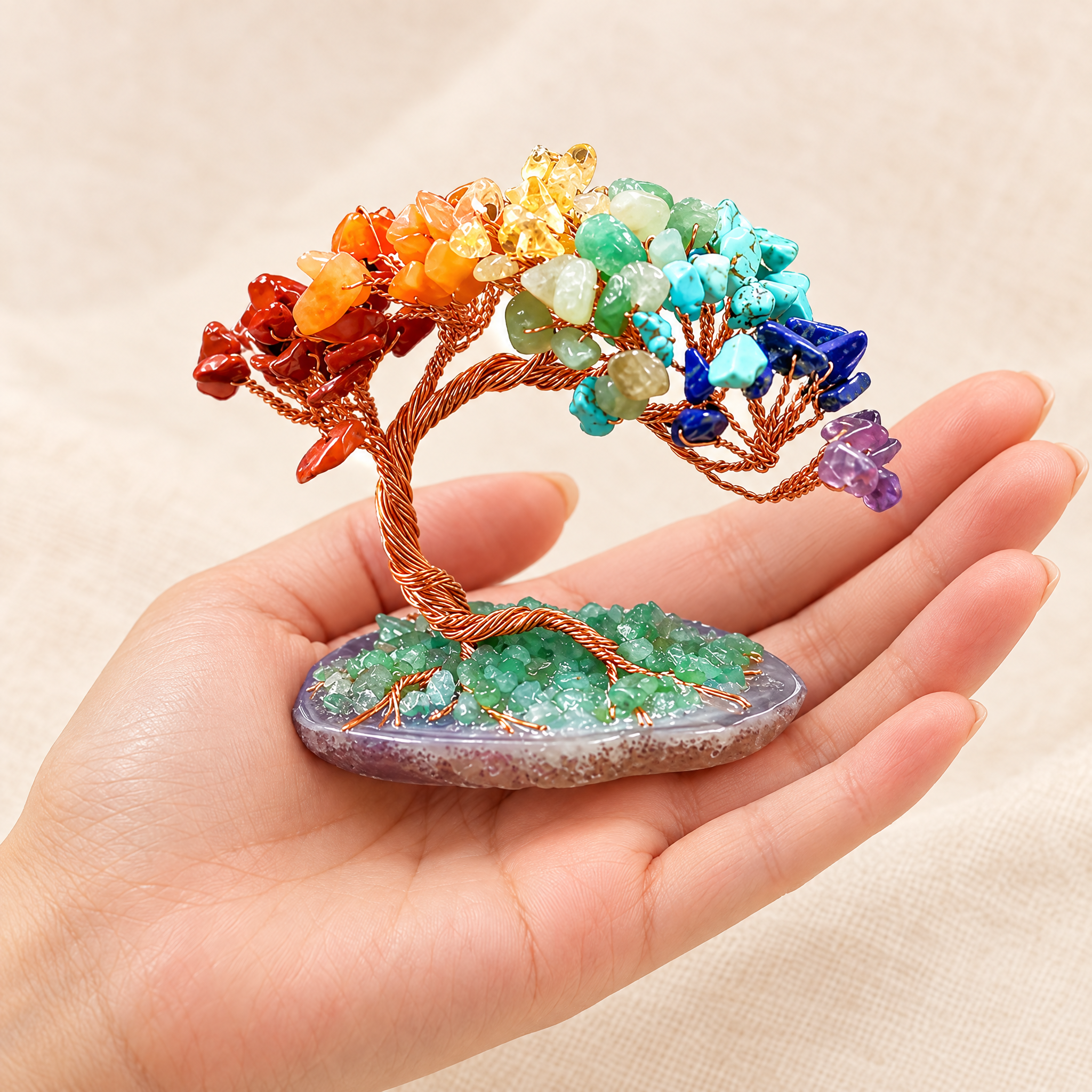 The gemstone tree in the palm of a hand to show its size